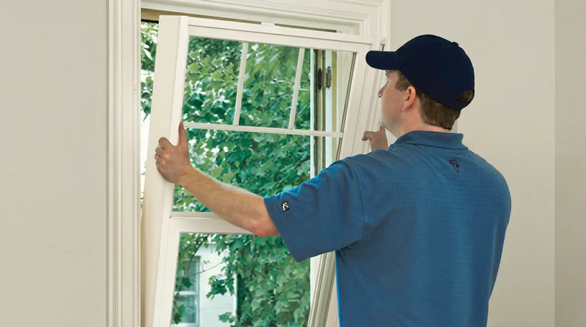 Professional contractors performing a residential window insulation and replacement service in Cambridge, MA
